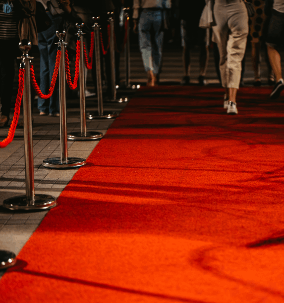 Red carpet VIP arrival with chrome stanchions and rope barriers — premium corporate event styling and guest experience management in New Zealand